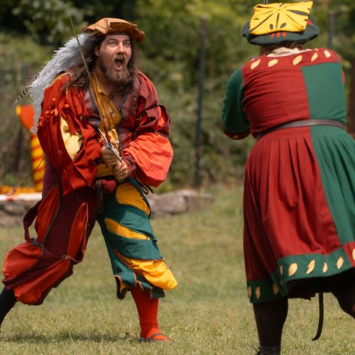 Predstavenie Landsknechti, muži a ženy v renesančných kostýmoch, šerm s mečmi